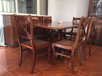 a wooden dining room table with chairs and a wooden floor at Miguel Bombarda Cozy Apartment in Porto