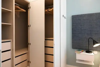 a closet with a white door and a lamp at Quadra Apartment - Luxury & Relaxation in Porto