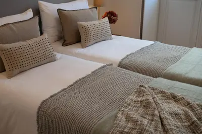 two beds sitting next to each other in a bedroom at Quadra Apartment - Luxury & Relaxation in Porto