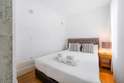 a bedroom with a large white bed with two pillows at GuestReady - Lovely heaven in Porto in Porto