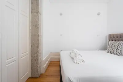 a bedroom with a white bed with towels on it at GuestReady - Lovely heaven in Porto in Porto