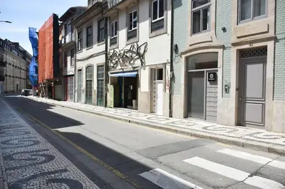 an empty street in a city with buildings at Apartment with balcony in the center of Porto in Porto