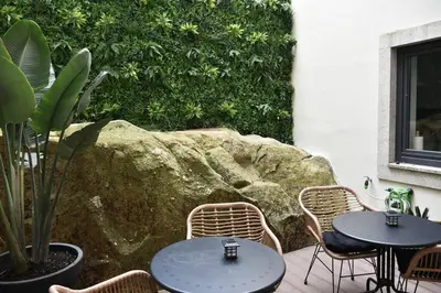 two tables and chairs sitting on a patio at Apartment with balcony in the center of Porto in Porto