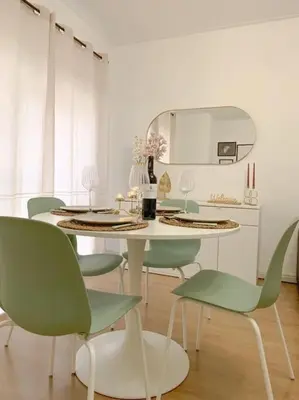 a dining room with a white table and green chairs at Oporto Music Flat - Very Central & Free Parking in Porto