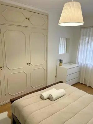 a bedroom with a bed with two towels on it at Oporto Music Flat - Very Central & Free Parking in Porto