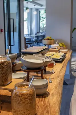 a table with jars of food and bowls of food at Holiday Inn Express Porto - Boavista by IHG in Porto