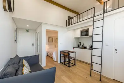 a living room with a couch and a loft at Clérigos Apartments Porto - Premium in Porto