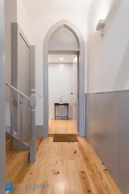 a hallway with an archway and a wooden floor at Quinta da Boa Vista Garden & Terrace in Porto