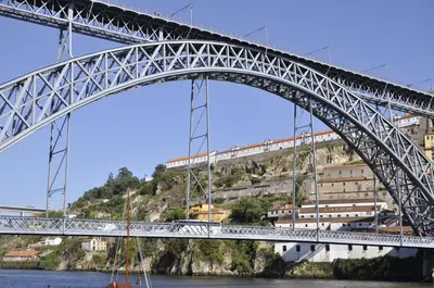 a bridge over the water with a train on it at Quinta da Boa Vista Garden & Terrace in Porto