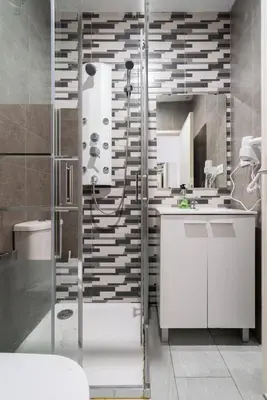 a bathroom with a shower and a white sink at Moreira Terrace in Porto