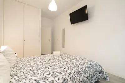 a bedroom with a bed and a tv on the wall at Moreira Terrace in Porto