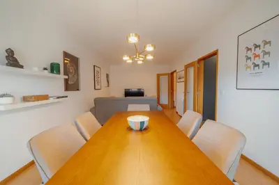 a dining room with a wooden table and chairs at Boavista Premium by Hosty in Porto