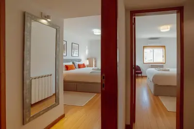 a room with two beds and a mirror at Boavista Premium by Hosty in Porto