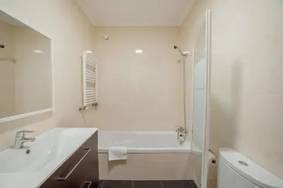 a bathroom with a tub and a sink and a shower at Boavista Premium by Hosty in Porto