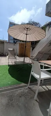a dining room table with chairs and a clock on the wall at Boho House Terrace in Porto