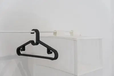 a metal towel rack hanging on a white counter at PortoNest Downtown Suites in Porto