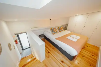 a bedroom with a bed in a small room at Lapa Cozy by Hosty in Porto