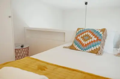 a bed with two pillows on top of it at Lapa Cozy by Hosty in Porto