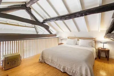 a bedroom with a large bed with white sheets at Fly me to the Moon in Porto
