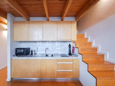 a kitchen with a sink and a staircase at Fly me to the Moon in Porto