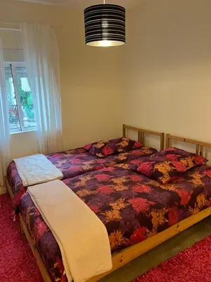 a bedroom with a bed with a colorful comforter at River Place in Porto