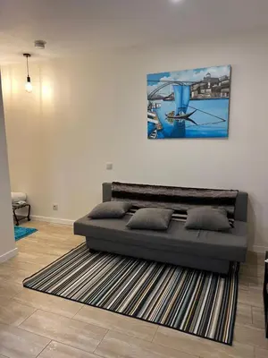 a bed in a room with a painting on the wall at River Place in Porto