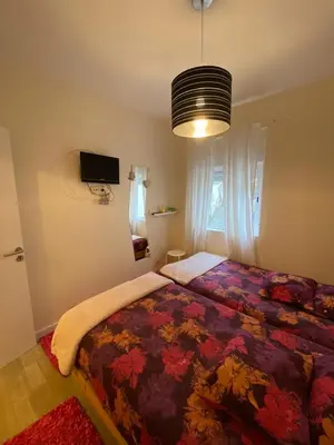 a bedroom with a bed with a colorful blanket at River Place in Porto