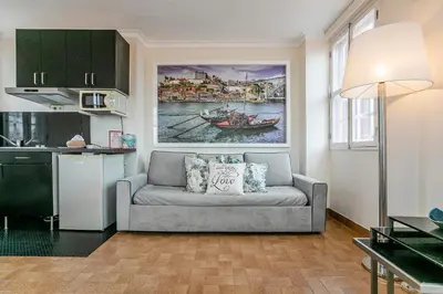 a living room with a couch in a kitchen at Stunning Clerigos Duplex apartment in the heart of Porto in Porto