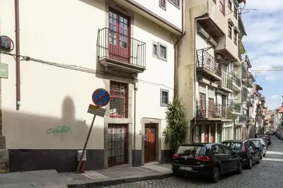 a street with cars parked in front of buildings at Clerigos Studio Apts in Porto