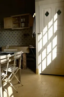a door leading into a kitchen with a table and chairs at Casa Astória - City Centre Historical Building with Amazing River View in Porto