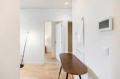 a dining room with a table and a white wall at GuestReady - A secret passage in Porto in Porto
