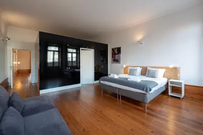 a bathroom with a tub and a sink and a toilet at Fontainhas Flat: Balcony & Parking in Porto