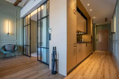 a kitchen with glass doors and a hallway with wood floors at Riverside Oasis by LovelyStay in Vila Nova de Gaia