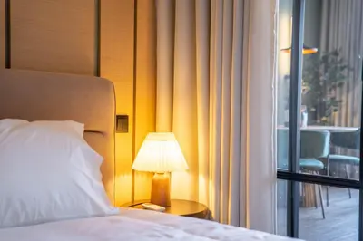 a bed with a lamp on a table next to a window at Riverside Oasis by LovelyStay in Vila Nova de Gaia