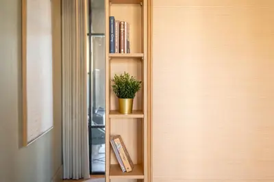 a book shelf with a plant in it next to a door at Riverside Oasis by LovelyStay in Vila Nova de Gaia