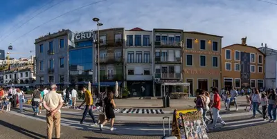 a group of people walking on a street with buildings at Riverside Oasis by LovelyStay in Vila Nova de Gaia