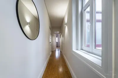 a hallway with a mirror on the wall at Nomad's Family - 3BDR Charming Hideouts Porto in Porto