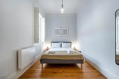 a bedroom with a bed in a white room at Nomad's Family - 3BDR Charming Hideouts Porto in Porto