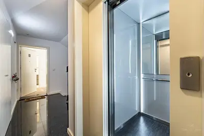 a glass door leading to a hallway with a refrigerator at Nomad's Lux - 1BDR The Silent Nest in Bonfim in Porto