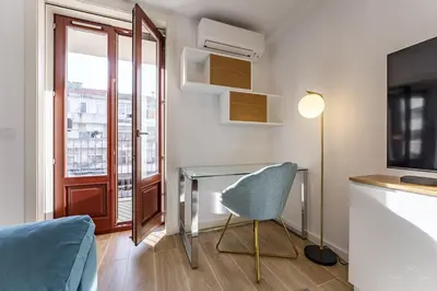 a room with a desk and a chair and a window at Nomad's Lux - 1BDR The Silent Nest in Bonfim in Porto