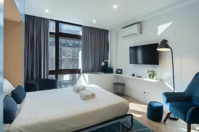 a hotel room with a bed with a teddy bear on it at GuestReady - Oporto Blue Douro Residence in Porto