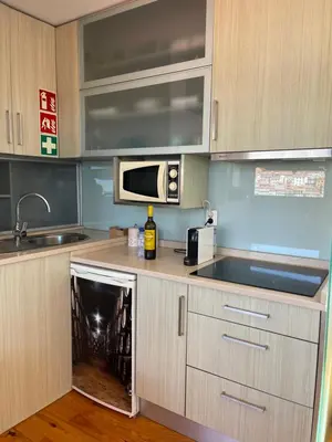 a kitchen with a dishwasher in the middle at Douro River Apartments in Vila Nova de Gaia