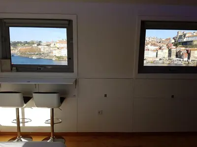 two windows in a room with a view of a city at Douro River Apartments in Vila Nova de Gaia
