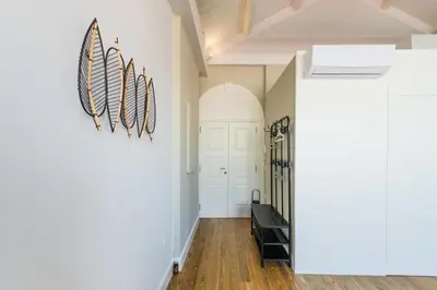a hallway with a white door and a staircase at Frei Yellow Studio in Porto