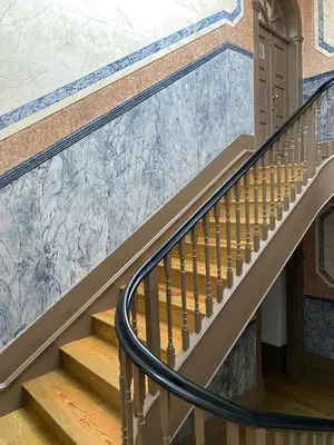 a staircase in a house with a marble wall at Frei Yellow Studio in Porto
