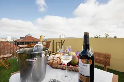a bottle of wine and two glasses on a table at Porto Bello - Apartamento -1 in Porto
