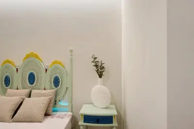 a bedroom with a bed and a vase on a table at Porto Bello - Apartamento - 2 in Porto