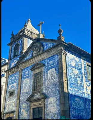 a blue and white building with a cross on top at Porto Bello - Apartamento - 3 in Porto