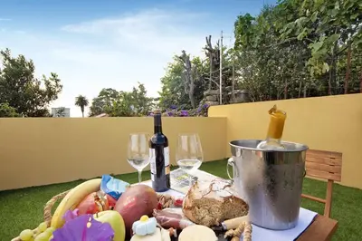 a table with a basket of food and two wine glasses at Porto Bello - Apartamento - 3 in Porto