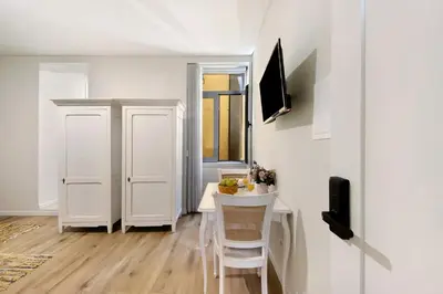 a small white room with a table and a chair at Porto Bello - Apartamento - 4 in Porto